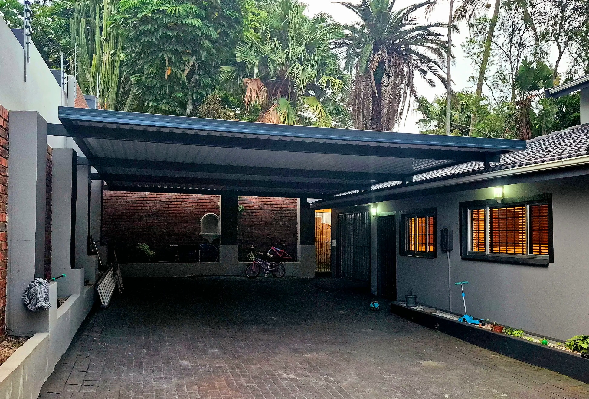 Driveway awning installation in Durban - Long-span carport over brick-paved driveway
